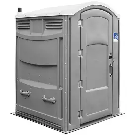 Spacious wheelchair-accessible portable restroom with flat-floor entry and side handrails, designed for easy mobility.