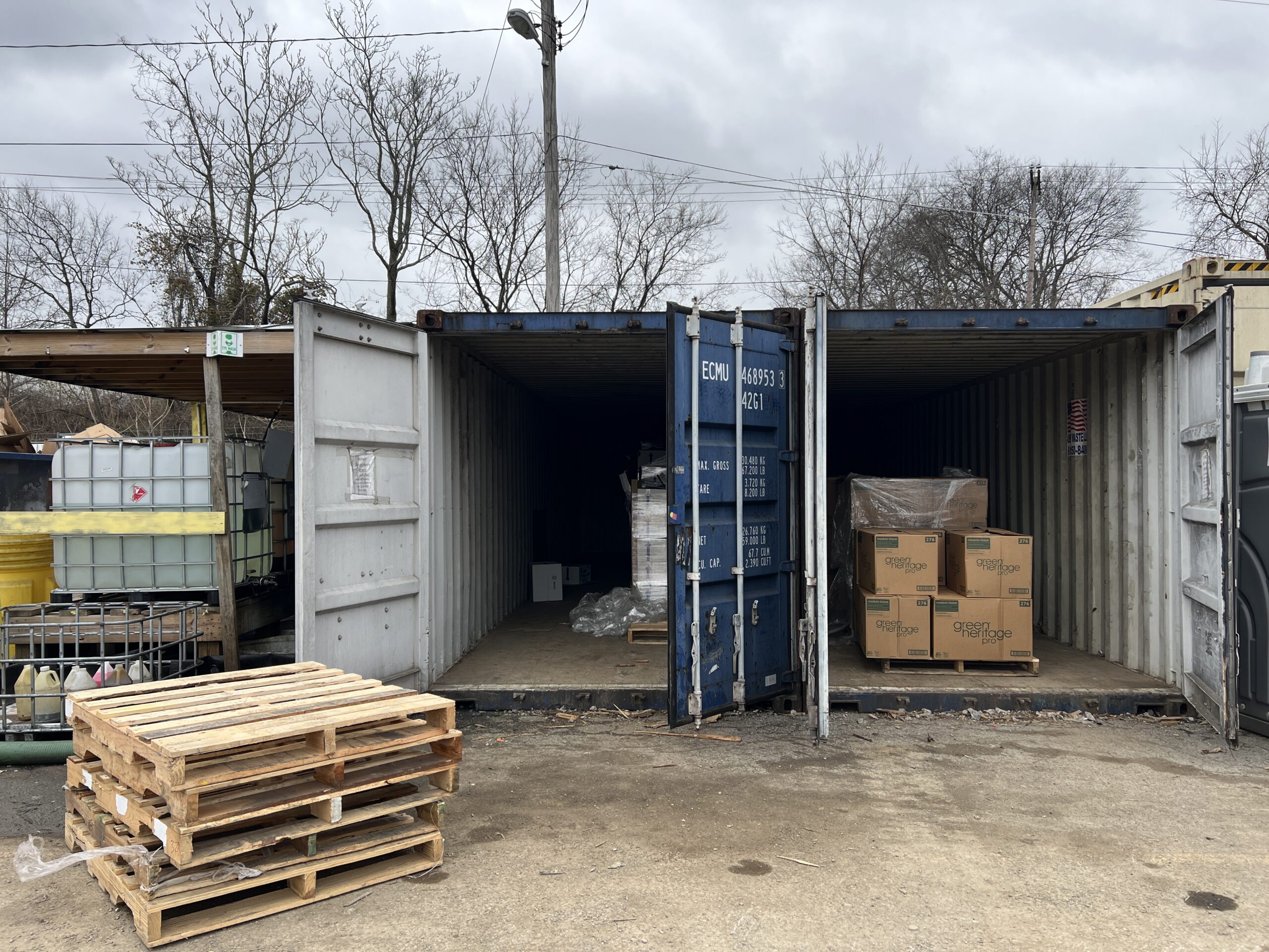 Stacked portable storage containers at a secure outdoor facility available for rent.