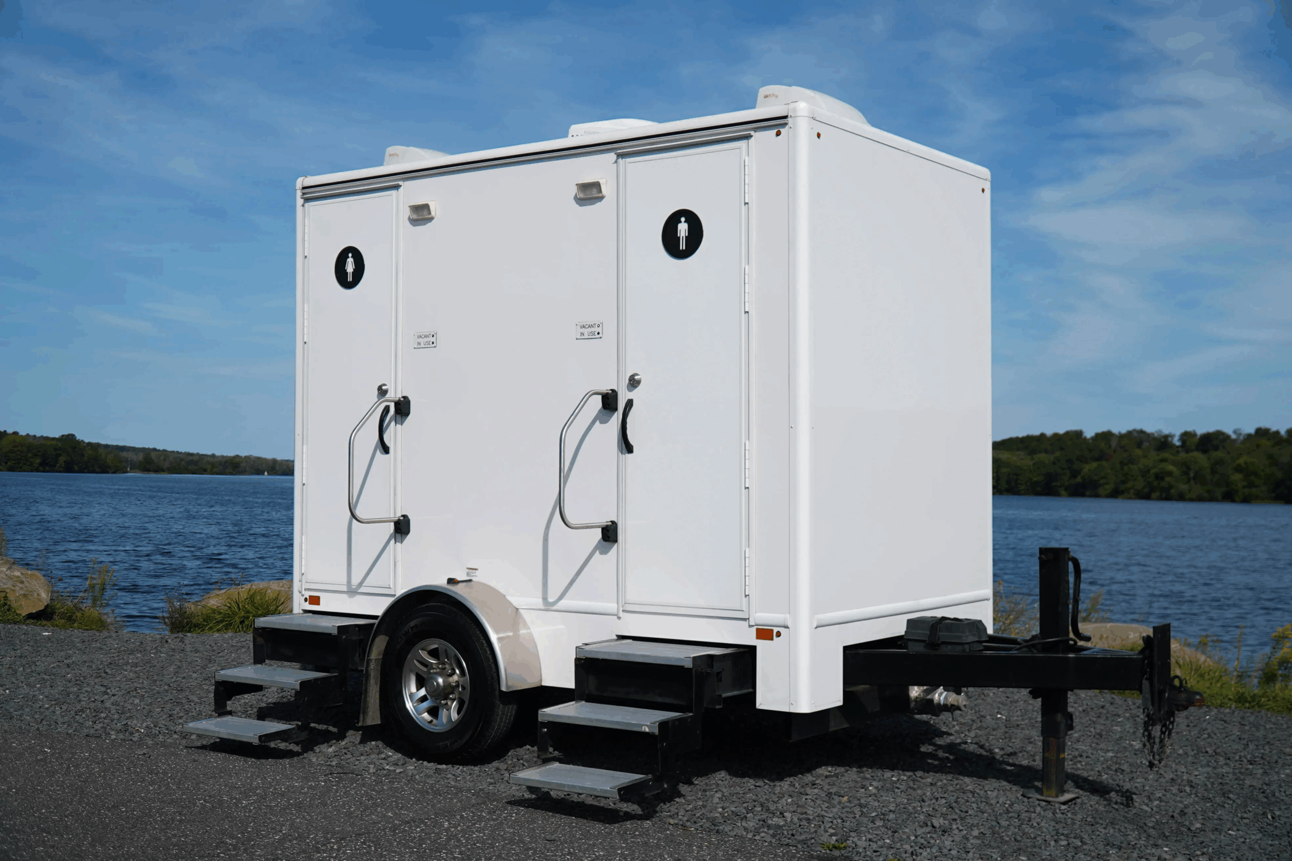Luxury restroom trailer with multi-stall layout, steps, and handrails for premium event sanitation.