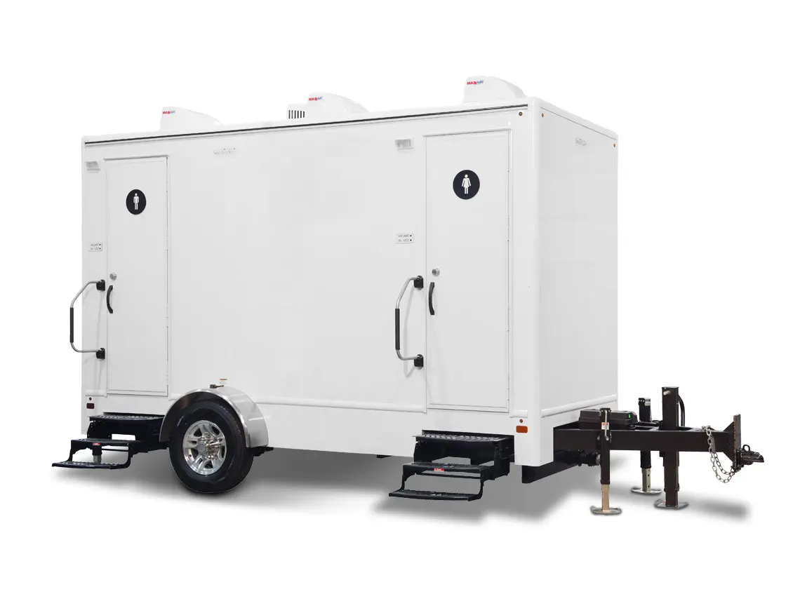 Upscale portable restroom trailer featuring flush toilets, sinks, and climate-controlled interiors.