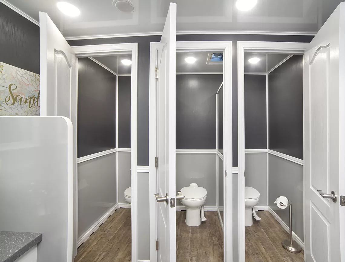 Portable restroom trailer with bright, professional finish designed for weddings and VIP events.