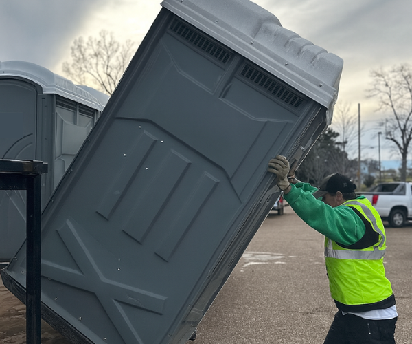 Portable toilet rental graphic—single-unit restroom on neutral background.