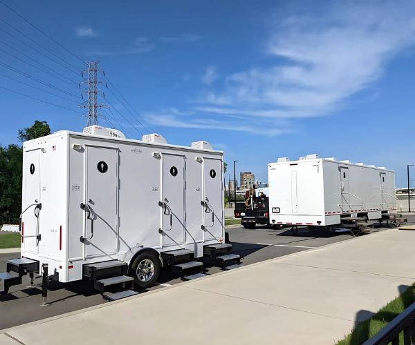 Restroom trailer graphic—portable luxury bathroom unit on neutral background.