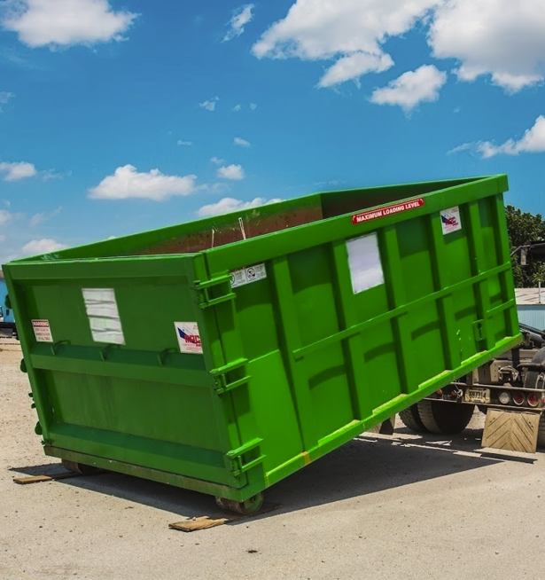 Heavy-duty roll-off container on wheels for easy placement and pickup.
