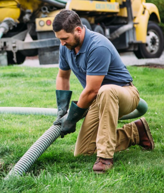Septic tank pumping service—vacuum truck removing wastewater from a residential tank.