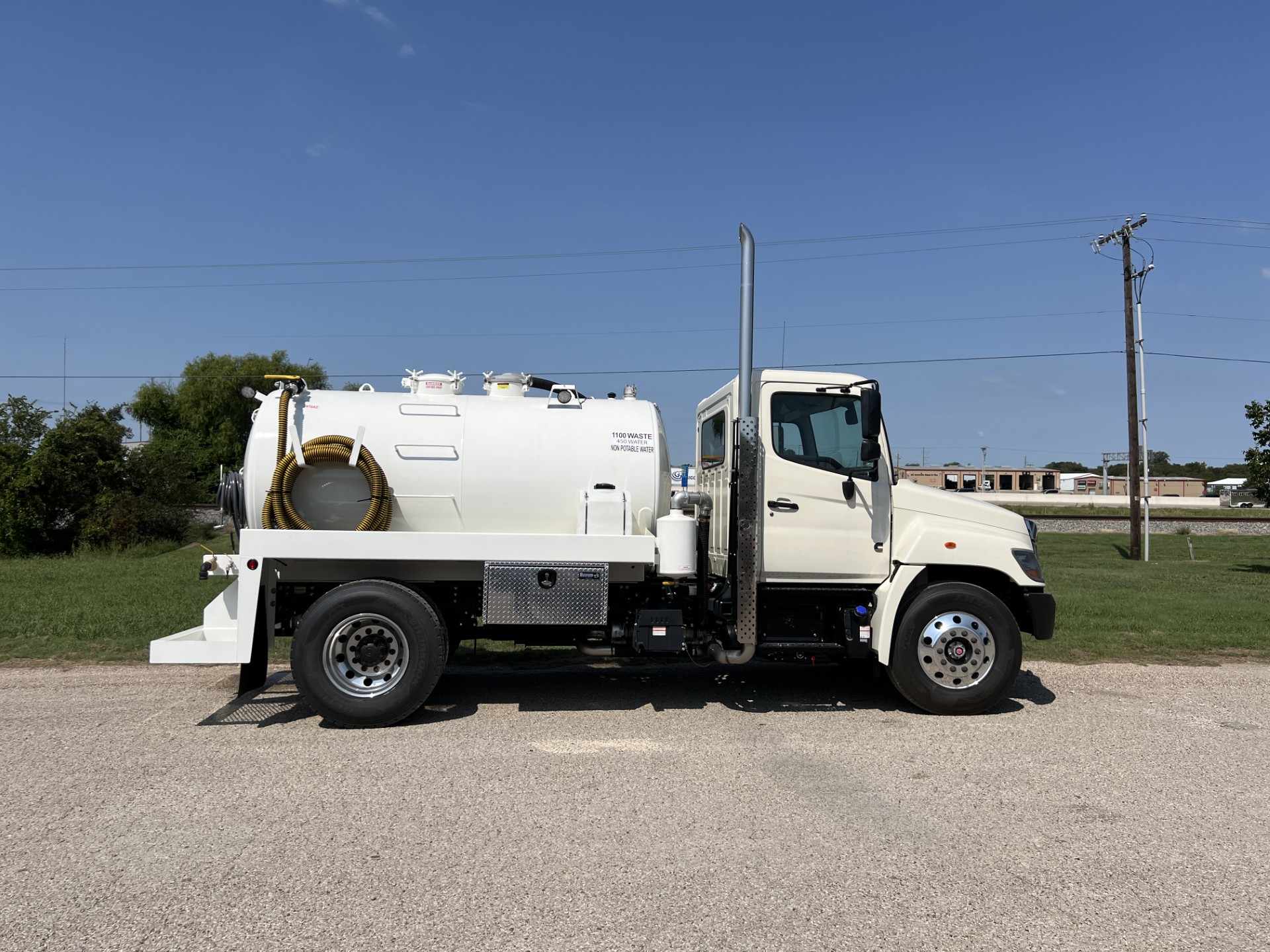 Drone photo of fleet vehicles and equipment used for septic pumping and service.